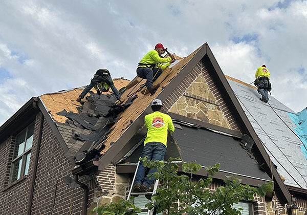 Roofers installing shingles on home in Frisco TX