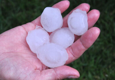 Golf size hail in a persons hand in Hebron TX